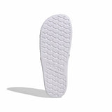 White shoe sole with tread pattern on a light gray background