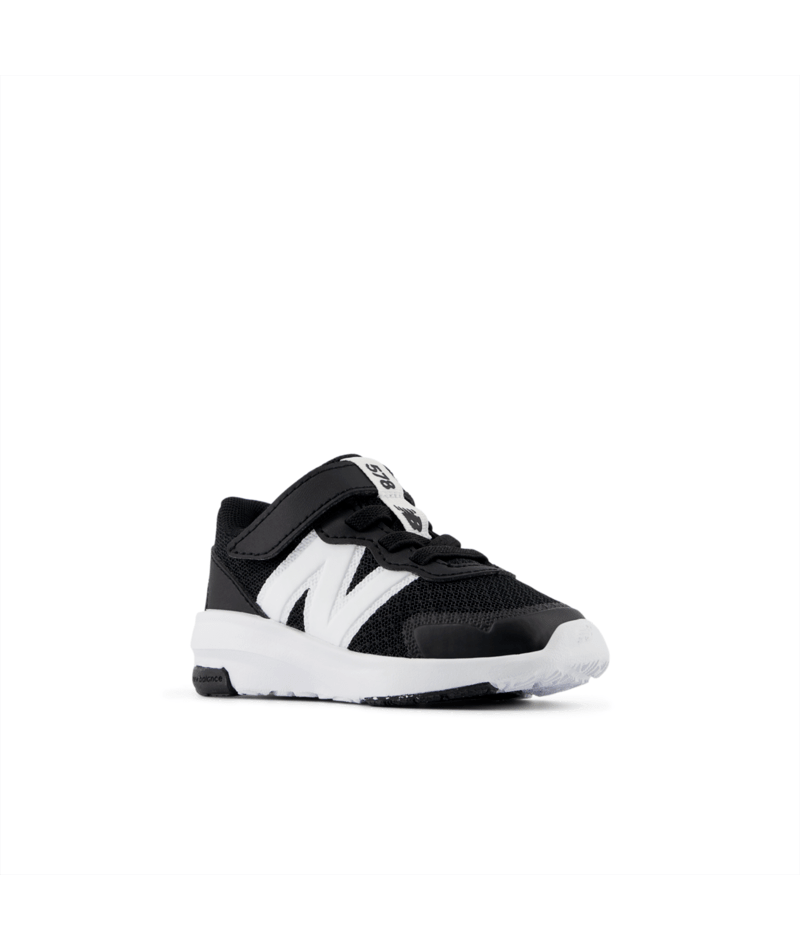 Black and white sneaker with a visible brand logo on a white background