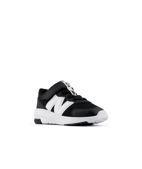 Black and white sneaker with a visible brand logo on a white background