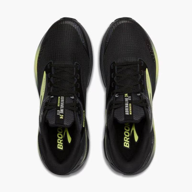 Black running shoes with yellow accents on a white background