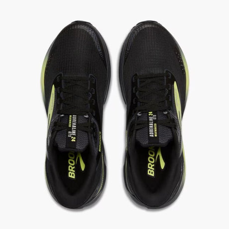 Black running shoes with yellow accents on a white background