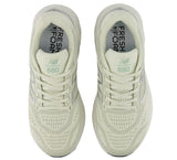Pair of light green New Balance 880 shoes on a white background