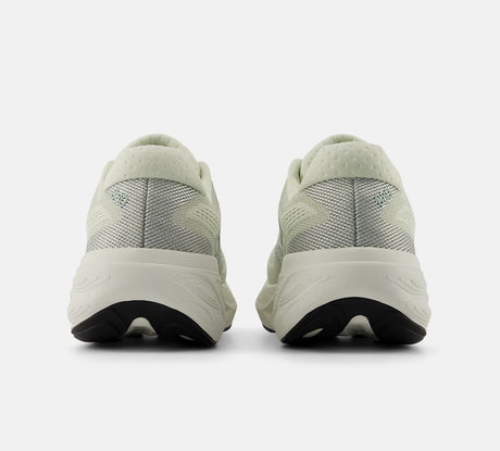 Light green running shoes with white soles on a white background
