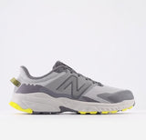 Gray running shoe with yellow accents on a light gray background