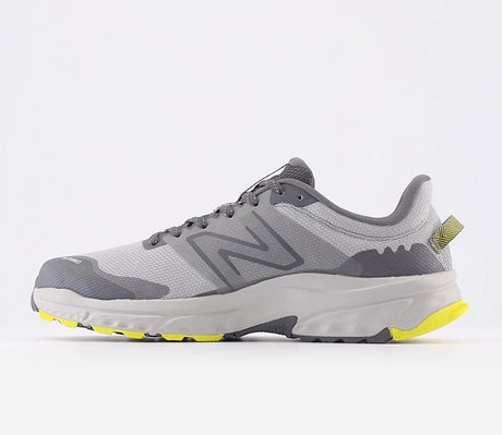 Gray and yellow running shoe on a white background