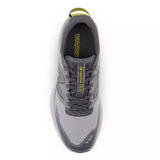 Gray athletic shoe with yellow accents on a white background