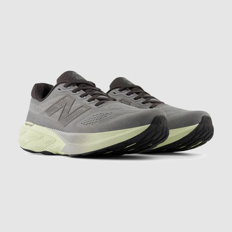 Gray running shoes with black and light green accents on a light gray background