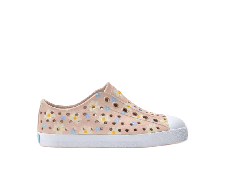 Beige sneaker with floral patterns on a light gray background