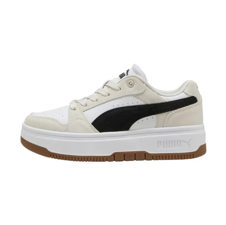 White sneaker with black Puma logo and brown sole on a white background