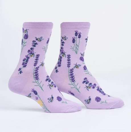 Pair of purple socks with lavender flower and bee pattern on a white background
