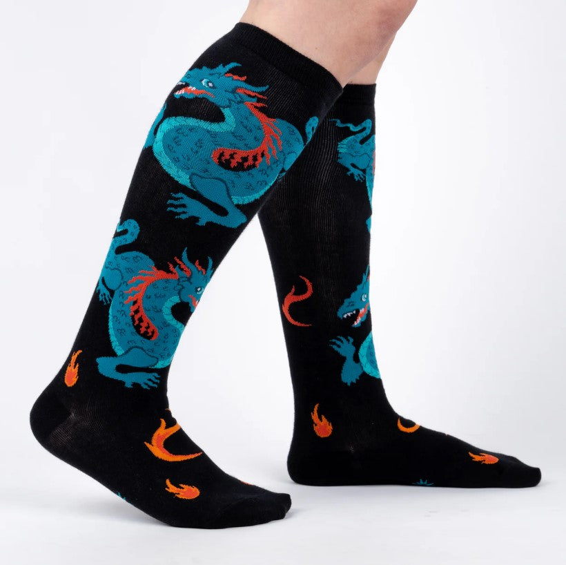 Black knee-high socks with blue dragon design on a white background