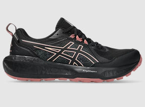 Black and pink running shoe on a gray background