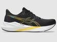 Black running shoe with yellow accents on a gray background