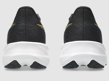 Black running shoes with white soles on a light gray background