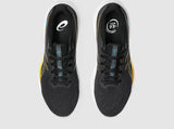 Black running shoes with yellow accents on a white background