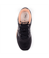Black sneaker with pink lining on a white background