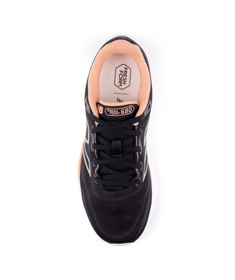 Black sneaker with pink lining on a white background