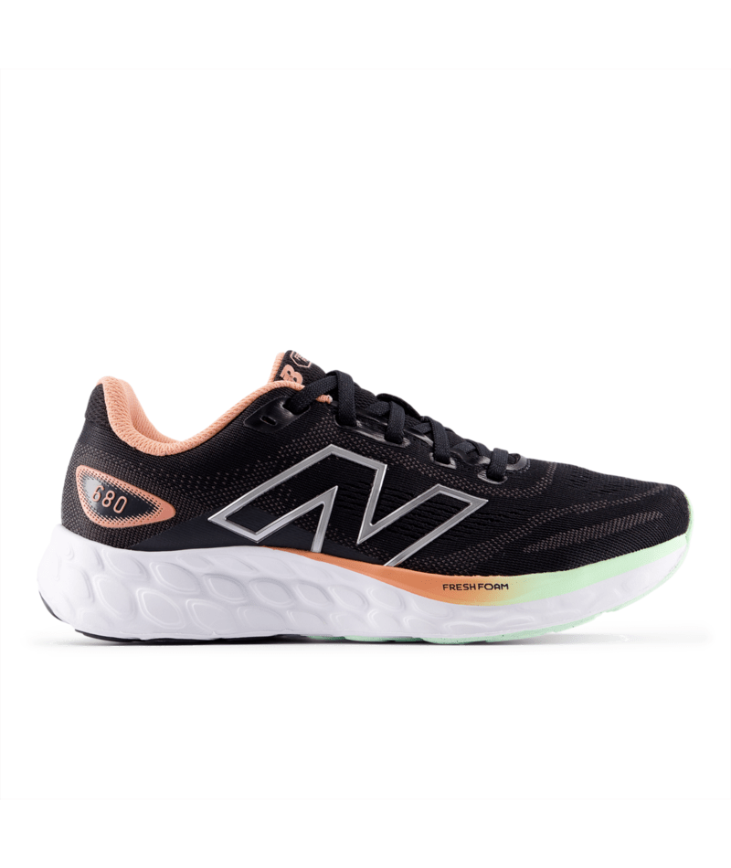Black New Balance running shoe with pink and green accents on a white background.  Can be purchased at www.sneakersplus.ca