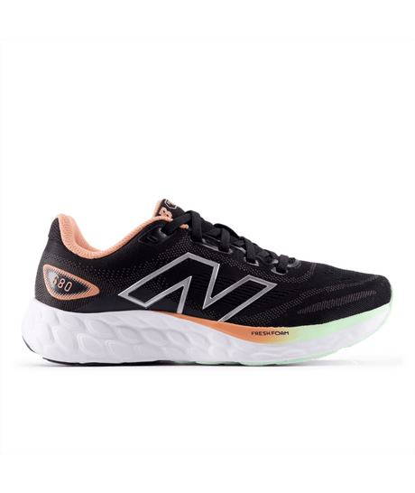Black New Balance running shoe with pink and green accents on a white background.  Can be purchased at www.sneakersplus.ca