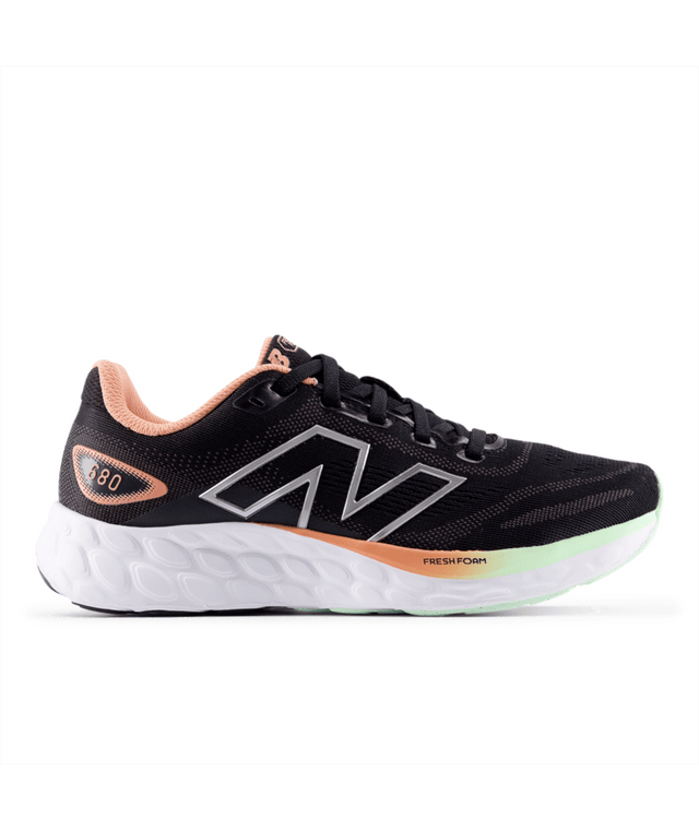 Black New Balance running shoe with pink and green accents on a white background.  Can be purchased at www.sneakersplus.ca