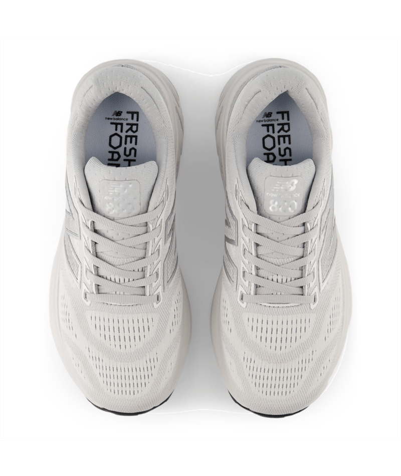 Pair of light gray running shoes with 'Fresh Foam' branding on a white background