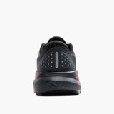 Black athletic shoe with red accents on a white background