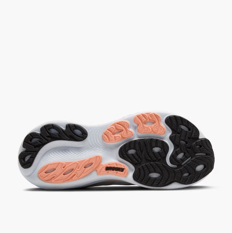 Close-up of a shoe sole with black and orange pattern on a white background