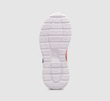 Close-up of a shoe sole with brand logo on a light gray background