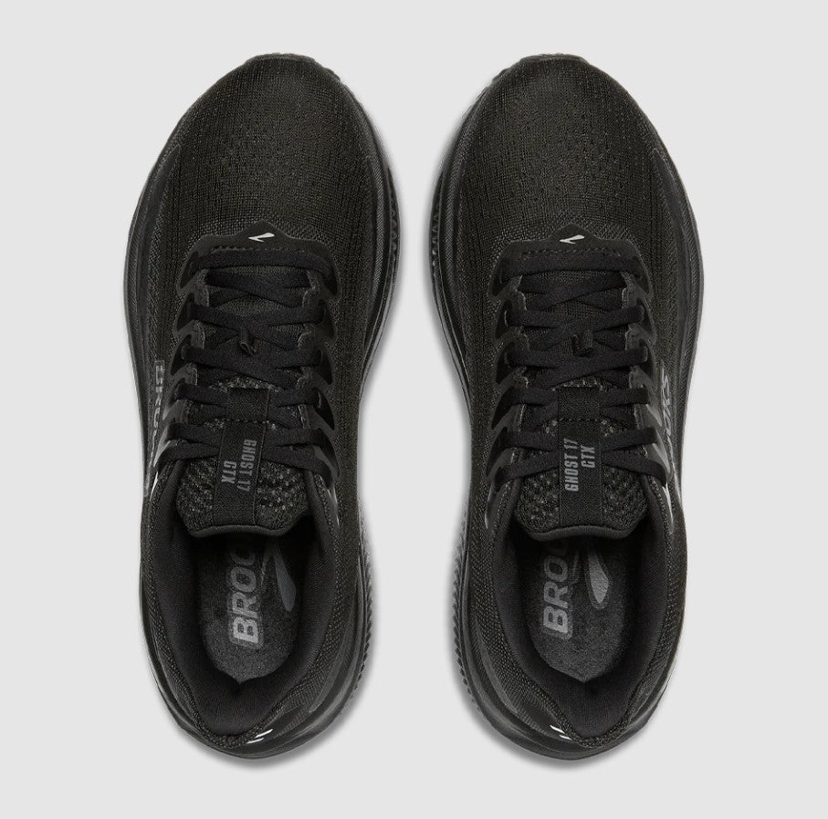 Black running shoes with 'Brooks' branding on a light gray background