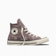 A single Converse All Star high-top sneaker in a dusty mauve-purple canvas with white floral and snake patterns, white laces, and a cream rubber toe cap and sole, shown against a plain white background.