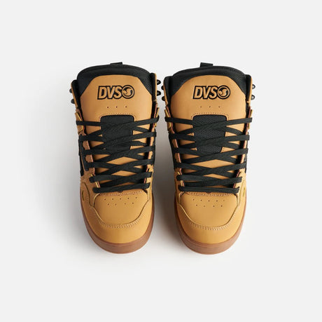 Pair of tan high-top sneakers with black laces on a white background