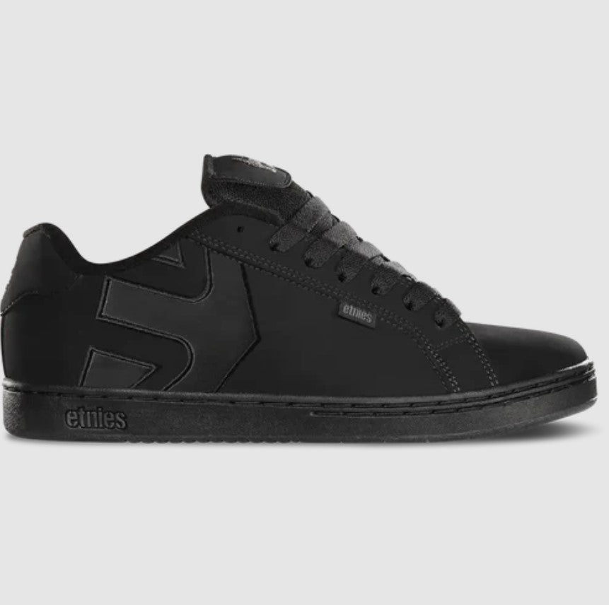 Black sneaker with brand logo on a gray background