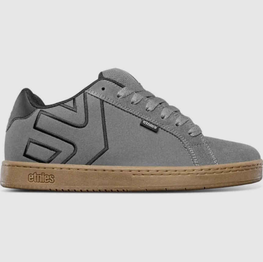 Gray sneaker with brown sole on a light gray background