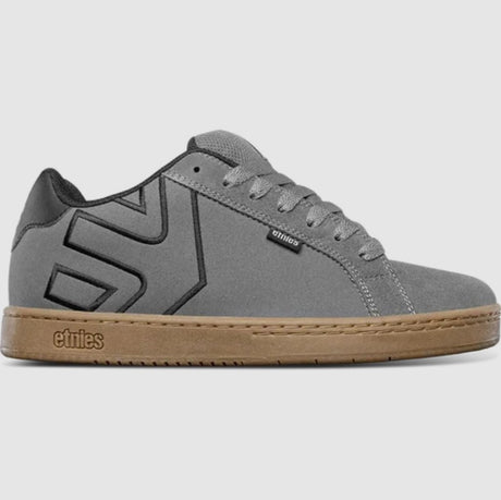 Gray sneaker with brown sole on a light gray background