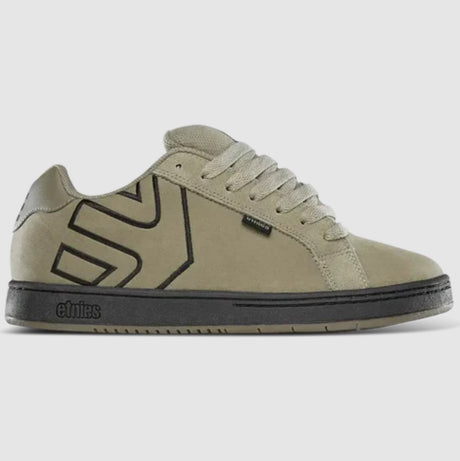 tan sneaker with black Etnies logo on a light gray background