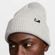 Gray knit beanie with a nike logo tag on a neutral background