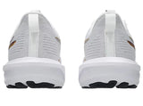 White athletic shoes with black soles on a light gray background