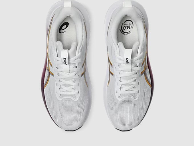 White running shoes with gold accents on a light gray background