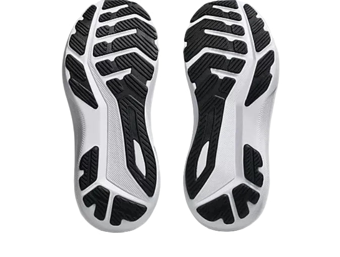 Close-up of white athletic shoes with black sole pattern on a light gray background