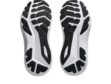 Close-up of white athletic shoes with black sole pattern on a light gray background