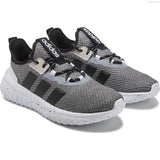 Gray Adidas sneakers with black stripes on a white background