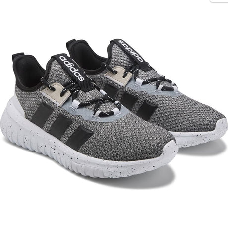 Gray Adidas sneakers with black stripes on a white background