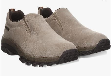 Pair of brown slip-on shoes with black soles on a white background
