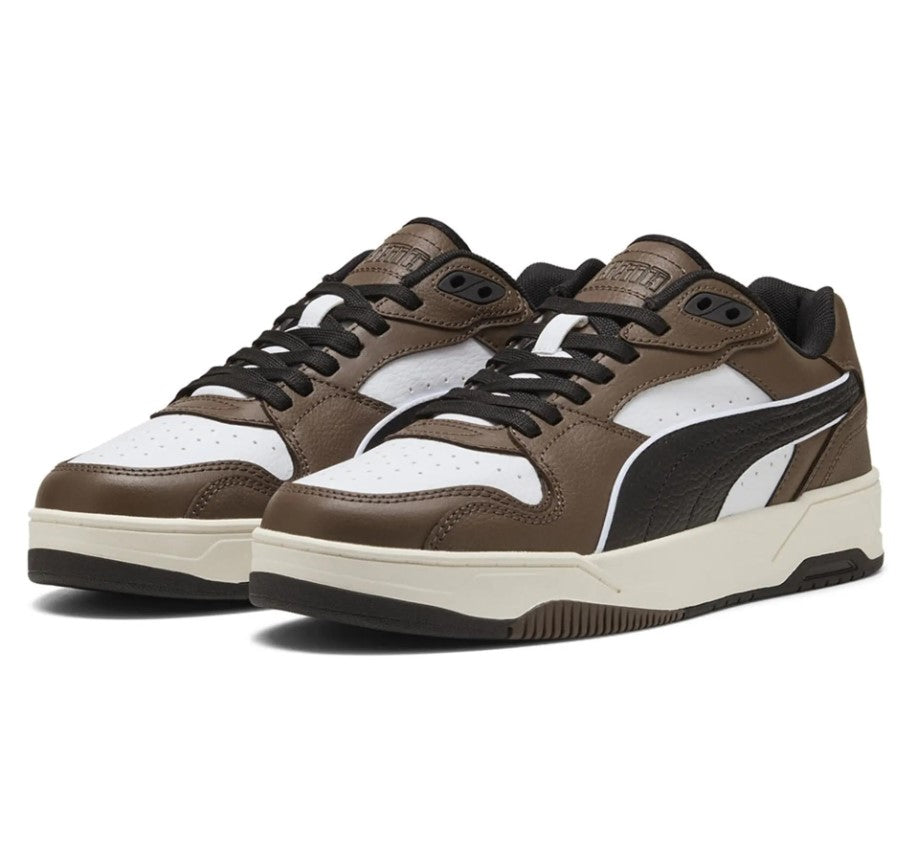 Brown and white Puma sneakers with black accents on a white background
