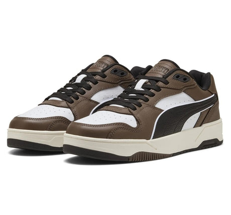Brown and white Puma sneakers with black accents on a white background