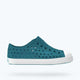 Teal shoe with white sole on a light gray background