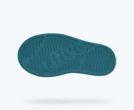 Teal sole of a shoe on a white background