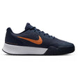 Side view of navy Nike shoes with an orange-bronze swoosh and a white and black sole