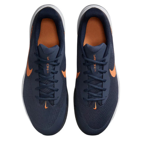 pair of navy Nike shoes with an orange-bronze swoosh on each side from a top down view