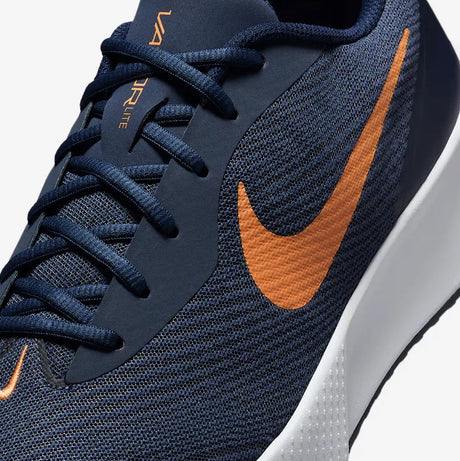 Close up view os  a navy and orange nike tennis shoe 